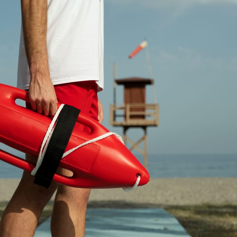 up close of lifeguard at beach with head and lower legs out of frame